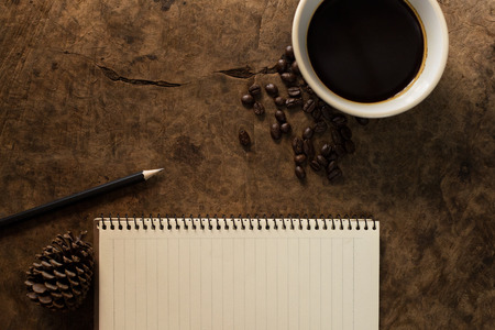 Work with a notebook and have coffee on the wooden floor.の写真素材