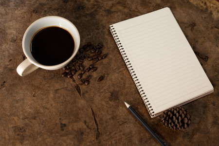 Work with a notebook and have coffee on the wooden floor.の写真素材