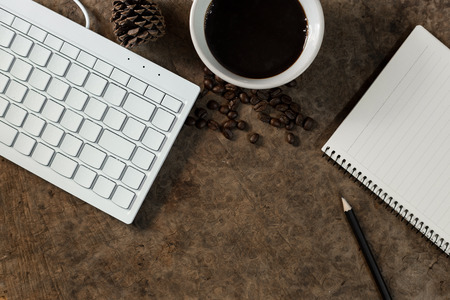 Work with the keyboard and have a coffee mug on the wooden floor.の写真素材