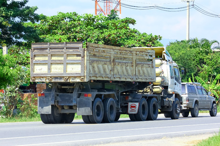 Chiangmai, Thailand - October 3, 2014: Trailer Dump truck of SayJomThong company. Photo at road no 121 about 8 km from downtown Chiangmai, thailand.のeditorial素材