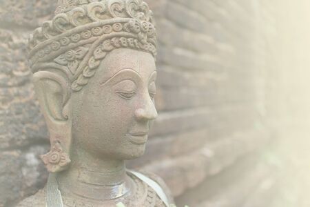 Close up of Buddha face statue in soft colorの写真素材
