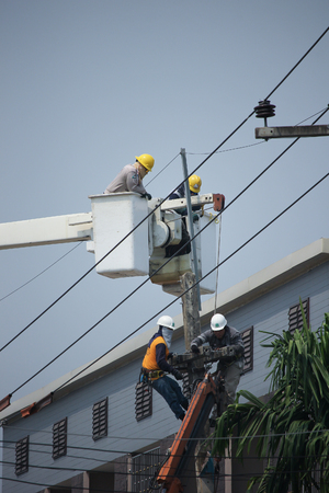CHIANGMAI, THAILAND -APRIL 10 2016:  Technician on Bucket truck of Provincial eletricity Authority of Thailands. Photo at rural road about 8 km from downtown Chiangmai, thailand.のeditorial素材