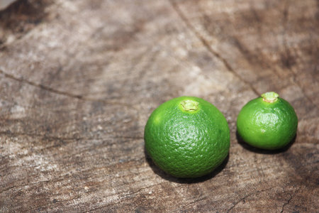Green lemon on wood Background
