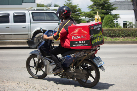 CHIANG MAI, THAILAND -SEPTEMBER 23 2017:  Delivery service man ride a Motercycle of Pizza Hut Company. On road no.1001, 8 km from Chiangmai city.のeditorial素材