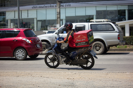 CHIANG MAI, THAILAND -SEPTEMBER 23 2017:  Delivery service man ride a Motercycle of Pizza Hut Company. On road no.1001, 8 km from Chiangmai city.のeditorial素材