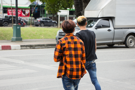 Chiangmai, Thailand - August  10 2018: Two Man Trying to cross the street directly across the crosswalk.  Photo on road in chiangmai city.のeditorial素材