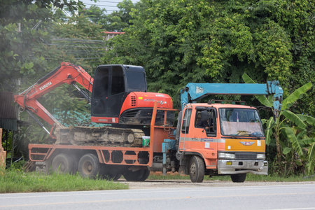 Chiangmai, Thailand - August  7 2018:  Private Kubota backhoe on truck. On road no.1001, 8 km from...