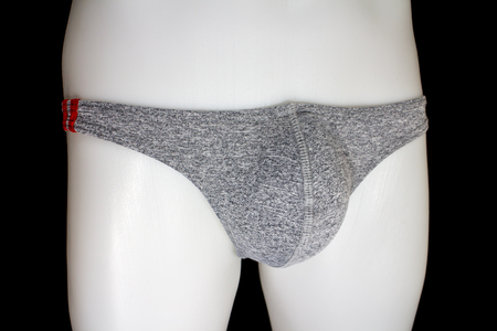 Thong Sexy T-Back Underwear on mannequin male on black backgroundの写真素材