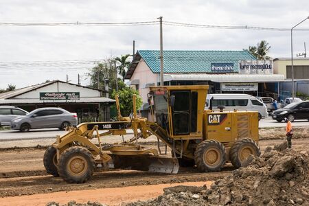 Chiangmai, Thailand - June 21 2019: Cat 140k motor grader on Construction site. Photo of new road no.121 outside ring road of chiangmai city.のeditorial素材
