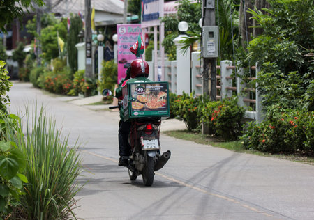 Chiangmai, Thailand - July 21 2019: Delivery service man ride a Motercycle of The Pizza Company. On...