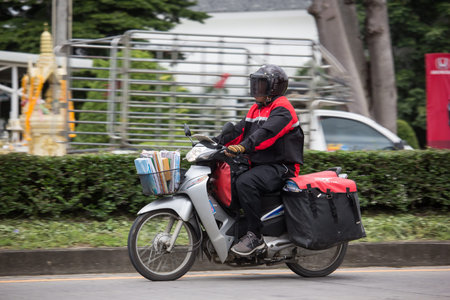 Chiangmai, Thailand - August 16 2019: Postman and Motercycle of Thailand Post. Photo at road no.121...