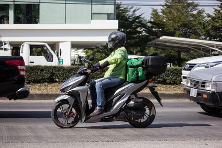 Chiangmai, Thailand - December 6 2019: Delivery service man ride a Motercycle of Grab Food. On road no.1001, 8 km from Chiangmai city.のeditorial素材