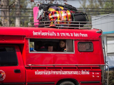 Chiangmai, Thailand - February 7 2020: Bag Cargo on top of  Red taxi chiang mai. On road no.1001 8 km from Chiangmai Business Area.のeditorial素材