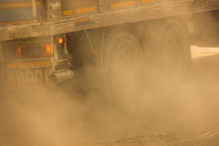 PM 2.5 from emissions and dust from trucks. On highway road.