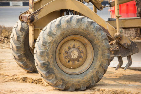 Chiangmai, Thailand - February 18 2020: Big Wheel of Cat 140k motor grader on Construction site. Photo of new road no.121 outside ring road of chiangmai city.のeditorial素材