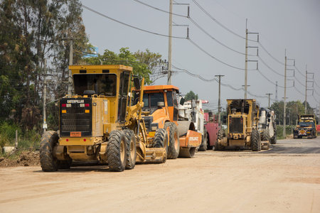 Chiangmai, Thailand -  April 14 2020: Cat 140k motor grader on Construction site. Photo of new road...