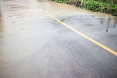 Flooding on the  asphalt  road from monsoon depressionの写真素材