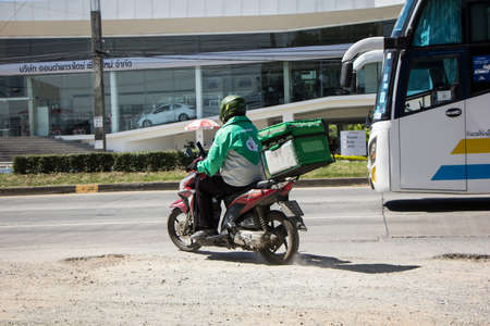 Chiangmai, Thailand -   October 21 2020: Delivery service man ride a Motercycle of Lineman. On road no.1001, 8 km from Chiangmai city.のeditorial素材