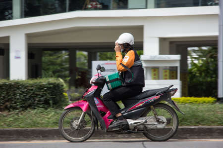 Chiangmai, Thailand -   November 3 2020: Delivery service man ride a Motercycle of 7-11. On road no.1001, 8 km from Chiangmai city.のeditorial素材