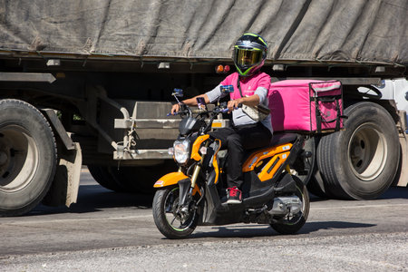 Chiangmai, Thailand -   November 27 2020: Delivery service man ride a Motercycle of Food Panda. On road no.1001, 8 km from Chiangmai city.のeditorial素材