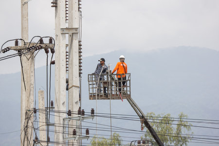 Chiangmai, Thailand - Auguest 10 2021:  Electricity Technician working for new cable. Team of  Provincial eletricity Authority of Thailands.のeditorial素材