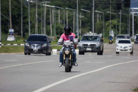 Chiangmai, Thailand - September 26 2021: Delivery service man ride a Motercycle of Food Panda. On road no.1001, 8 km from Chiangmai city.のeditorial素材