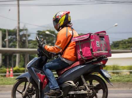 Chiangmai, Thailand - April  21 2022: Delivery service man ride a Motercycle of Shopee Food. On road no.1001, 8 km from Chiangmai city.のeditorial素材