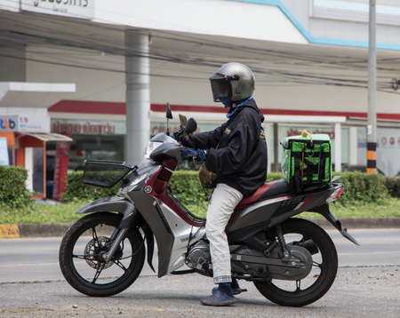 Chiangmai, Thailand - April  21 2022: Delivery service man ride a Motercycle of Grab Food. On road no.1001, 8 km from Chiangmai city.のeditorial素材