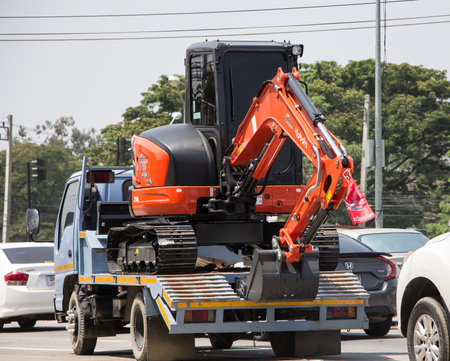Chiangmai, Thailand - April  21 2022: Private Kubota backhoe on truck. On road no.1001, 8 km from Chiangmai city.のeditorial素材
