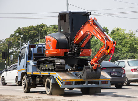 Chiangmai, Thailand - April  21 2022: Private Kubota backhoe on truck. On road no.1001, 8 km from Chiangmai city.のeditorial素材