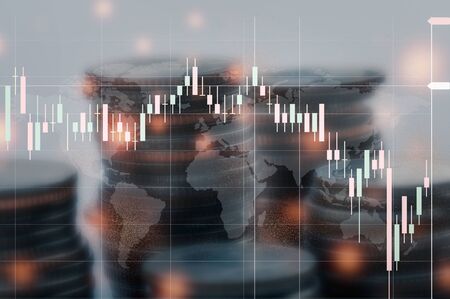 Double exposure of stock chart is falling, with the backdrop being a stack of coins.の写真素材