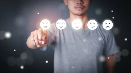 Man wearing a t-shirt Press the face icon Feeling on screen Virtual - Iconの写真素材