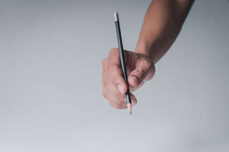 The man's hand showing the writing gesture on the tablet on the white background.の写真素材