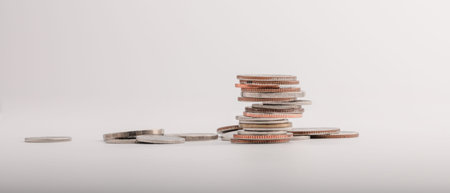 Piles of Thai baht coins arranged in descending order, concept of money and statistics, investment...