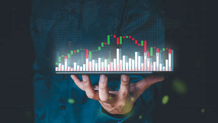 Businessman hand show Stock chart showing rising stock sign with graph indicator. Interest rate financial and mortgage rates concept.の写真素材