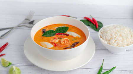 Tom Yum Kung and Fish Balls, Thai food placed on white wooden scene with side dishes.の写真素材