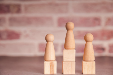 Businessman wearing a blue shirt, arranging the empty wooden blocks with his hands. Which is placed on a white wooden table. Business strategy and action plan. Copy space.の写真素材
