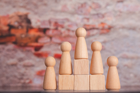 Businessman wearing a blue shirt, arranging the empty wooden blocks with his hands. Which is placed on a white wooden table. Business strategy and action plan. Copy space.の写真素材