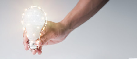 man with a light bulb graphics in his hand and the other side holds white stock graphics, concept...