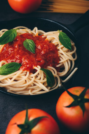 Spaghetti with tomato sauce and minced meat, Parmesan cheese and basil Black background.の写真素材