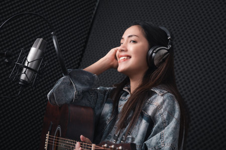 Asian female singer with a passion for music and microphone. While playing her guitar in a...