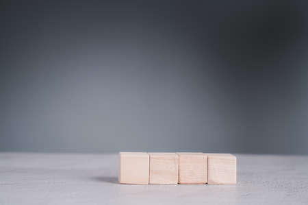 Businessman wearing a blue shirt, arranging the empty wooden blocks with his hands. Which is placed on a white wooden table. Business strategy and action plan. Copy space.の写真素材