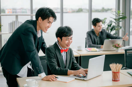 Group of young business people sit at their desks with smiling colleagues together in the office.  Meeting business people  planning concept, laptop meeting ideas. Concentrate on work. 
teamwork.の写真素材