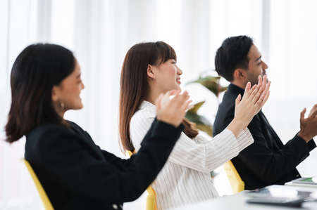Businessman applauding congratulations with a smiling face during the workshop in the conference room. Brainstorming and teamwork concept.の写真素材