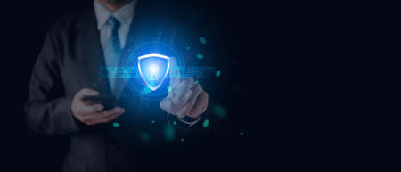 Data or network protection, businessman press shield icon, web button, virus cyber security. Insurance Digital crime by hacker concepts. Information security against viruses, System binary Matrix.の写真素材