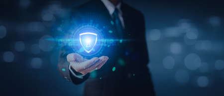 Data or network protection, businessman press shield icon, web button, virus cyber security. Insurance Digital crime by hacker concepts. Information security against viruses, System binary Matrix.の写真素材