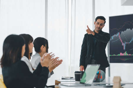 Businessman applauding congratulations with a smiling face during the workshop in the conference room. Brainstorming and teamwork concept.の写真素材