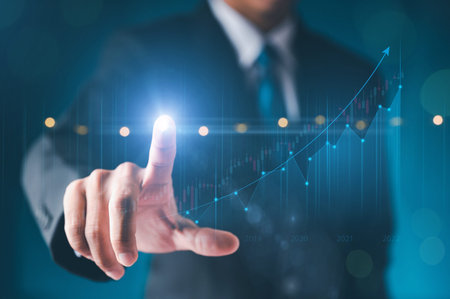 Businessman hand show Stock chart showing rising stock sign with graph indicator. Interest rate financial and mortgage rates concept. Double Exposure Image. Blue technology background high tech.の写真素材