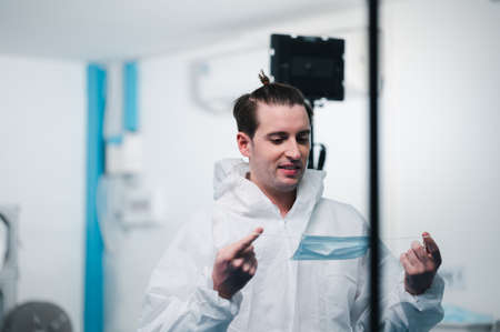 Scientists wearing uniform protection. Check the manufacturing process of face masks. In a laboratory at industry plants. The concept for security and protection coronavirus covid-19.の写真素材