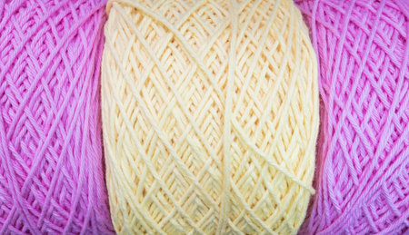 Closeup pile of purple and yellow yarn texture background